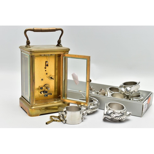 137 - A BRASS CARRIAGE CLOCK AND NAPKIN RINGS, brass carriage clock with glass viewing panels, unsigned wh... 