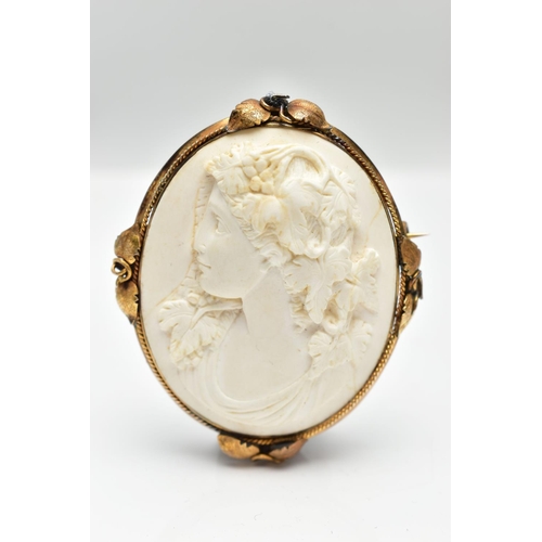 187 - A YELLOW METAL LAVA CAMEO BROOCH, the cameo carved to depict a lady in profile with floral detail to... 