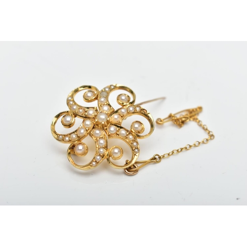 2 - A YELLOW METAL SPLIT PEARL FLORAL BROOCH, of scrolling design, the central split pearl with six scro... 