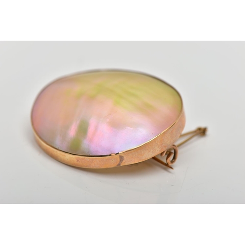 41 - A MID 20TH CENTURY YELLOW METAL MOTHER OF PEARL BROOCH, the mother of pearl panel, within a rub over... 