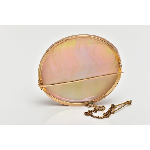 41 - A MID 20TH CENTURY YELLOW METAL MOTHER OF PEARL BROOCH, the mother of pearl panel, within a rub over... 