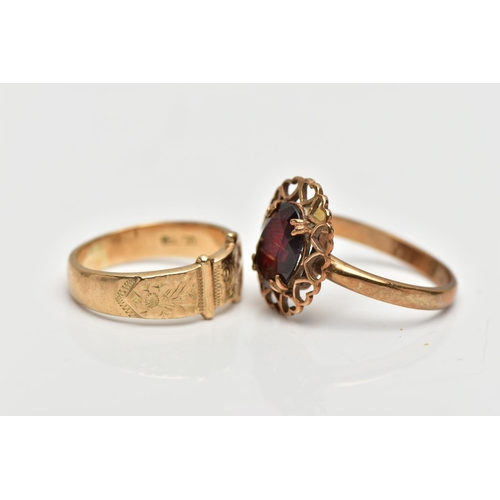 42 - TWO YELLOW METAL RINGS, to include a buckle ring, stamped 9ct, together with a garnet single stone r... 