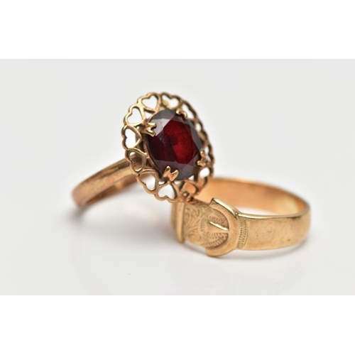 42 - TWO YELLOW METAL RINGS, to include a buckle ring, stamped 9ct, together with a garnet single stone r... 