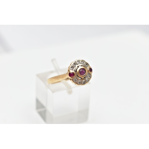 68 - A 14CT GOLD RUBY AND DIAMOND RING, designed with a central circular cut ruby collet set, flanked wit... 