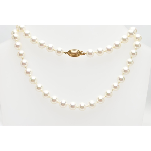 74 - A CASED IMITATION PEARL NECKLACE, a single row of white imitation pearl beads individually knotted o... 