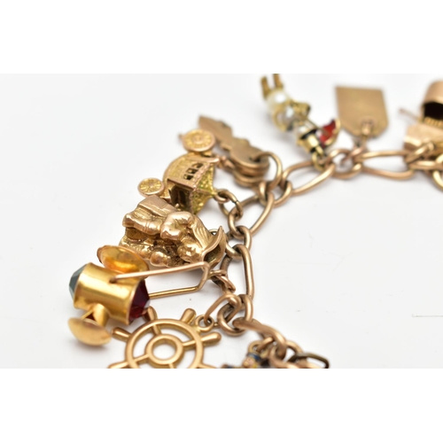 93 - A 9CT GOLD CHARM BRACELET SUSPENDING TWENTY FOUR CHARMS, the fancy link chain with lobster clasp, pa... 