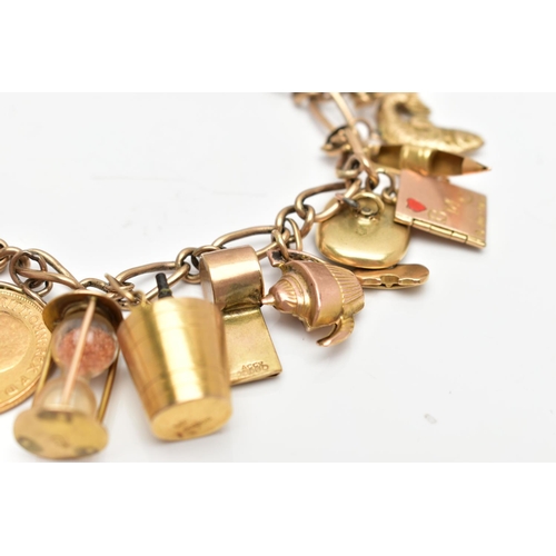 93 - A 9CT GOLD CHARM BRACELET SUSPENDING TWENTY FOUR CHARMS, the fancy link chain with lobster clasp, pa... 