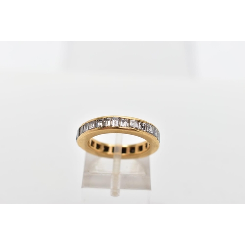 98 - A YELLOW METAL DIAMOND FULL ETERNITY RING, the band ring channel set with twenty seven princess cut ... 