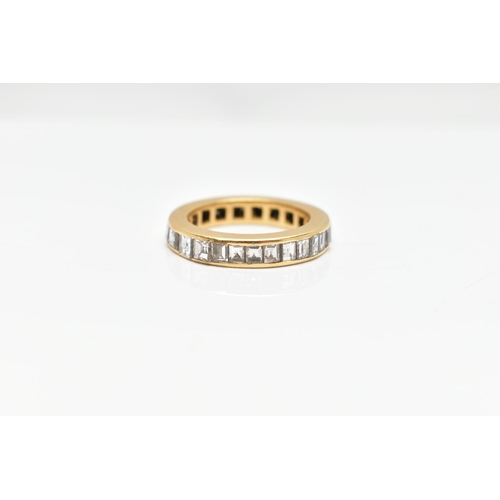 98 - A YELLOW METAL DIAMOND FULL ETERNITY RING, the band ring channel set with twenty seven princess cut ... 