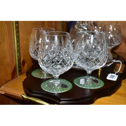 351 - A STUART CRYSTAL SHIPS DECANTER AND SIX BOXED BRANDY GLASSES, in Shaftesbury pattern, on a wooden pr... 