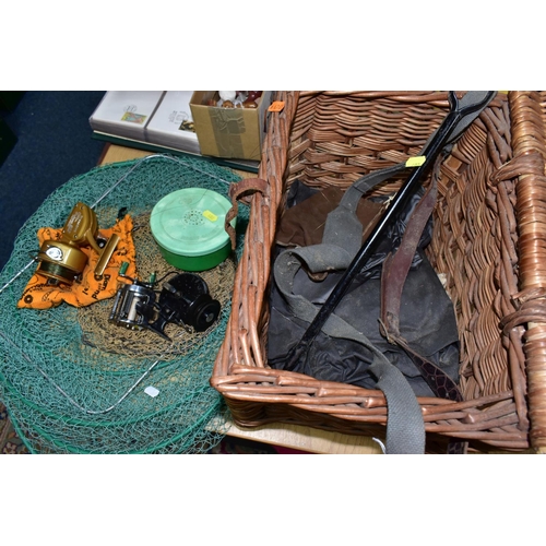 402 - A WICKER FISHING BASKET, KEEP NETS AND REELS, comprising a vintage wicker fishing basket with carry ... 