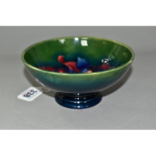 338 - A MOORCROFT POTTERY FOOTED BOWL, in Orchid pattern, with tube lined red and navy orchids on a blue g... 