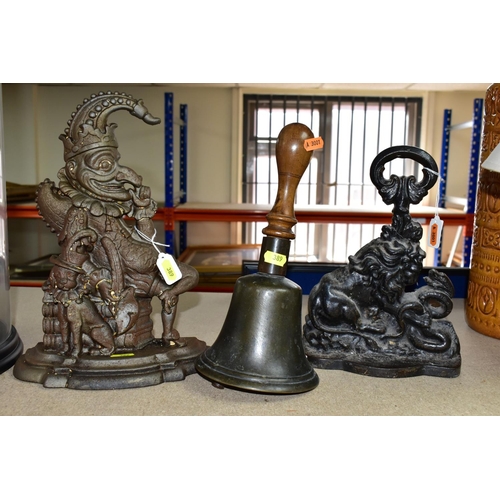 389 - A VINTAGE WOODEN HANDLED SCHOOL BELL AND TWO VICTORIAN CAST IRON DOORSTOPS, the bell height 28.5cm, ... 