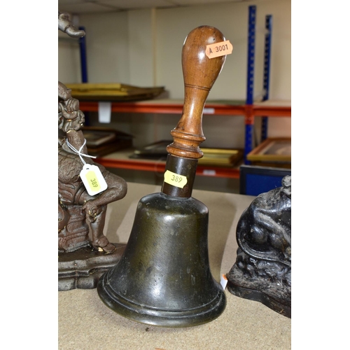 389 - A VINTAGE WOODEN HANDLED SCHOOL BELL AND TWO VICTORIAN CAST IRON DOORSTOPS, the bell height 28.5cm, ... 