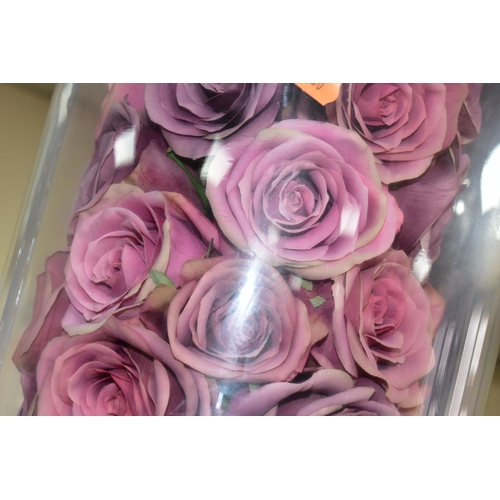 390 - A MODERN GLASS DOME ON A CIRCULAR EBONISED BASE, containing an arrangement of pink fabric roses, hei... 