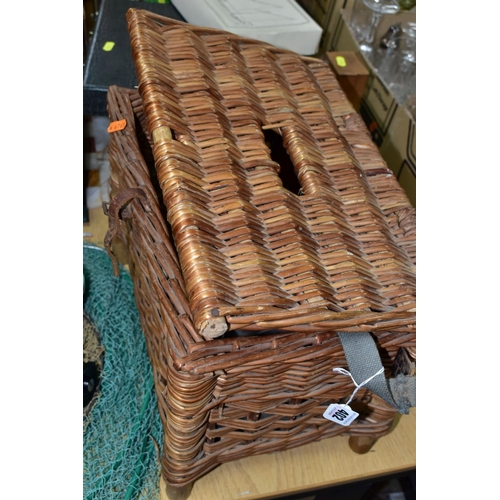 402 - A WICKER FISHING BASKET, KEEP NETS AND REELS, comprising a vintage wicker fishing basket with carry ... 