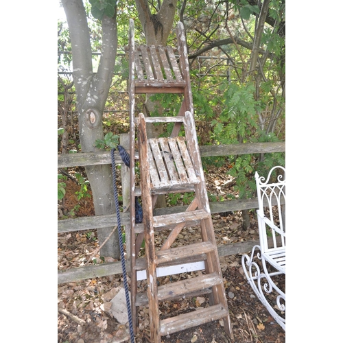 1035 - TWO VINTAGE WOODEN STEP LADDERS the tallest being 197cm high