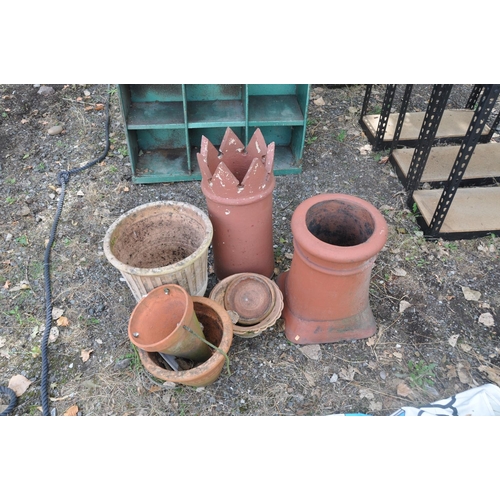 1037 - FIVE TERACOTTA PLANT POTS of various sizes and shapes and two chimney pots the tallest being  63cm