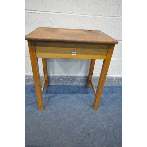 1335 - A PAIR OF 20TH CENTURY OAK SINGLE SCHOOL DESKS, with an metal banded open top lid, ink well section,... 