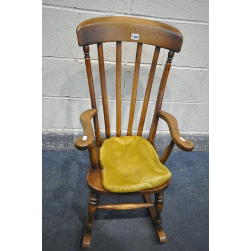 1483 - A REPRODUCTION OAK CHILDS ROCKING CHAIR, with a later fabric seat pad, width 41cm x depth 67cm x hei... 