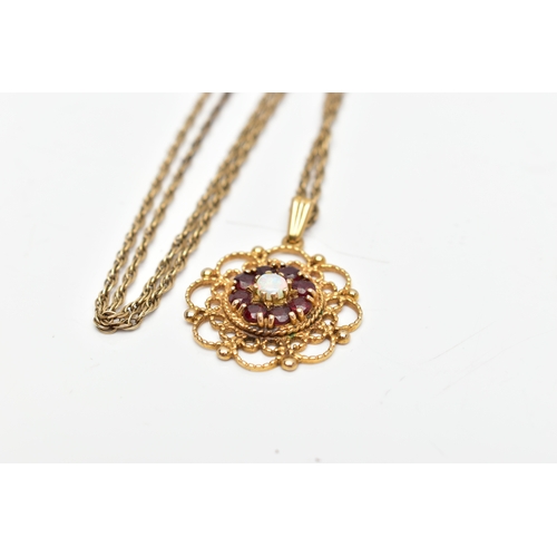 71 - A 9CT GOLD GEM SET PENDANT AND CHAIN, the pendant of an openwork circular form, centring on an eight... 