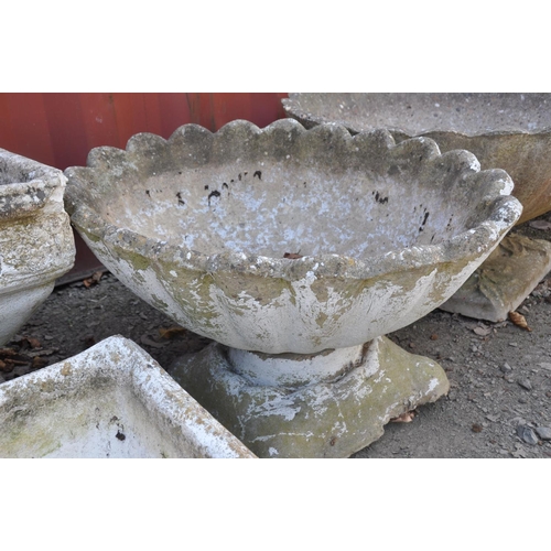 1005 - A COMPOSITE OVAL OYSTER SHELL GARDEN URN with shaped square base, width 71cm, depth 55cm, height 38c... 