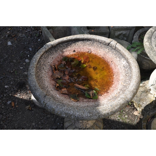 1013 - A MODERN COMPOSITE BIRD BATH on fluted and foliate detailed column base and a foliated detailed bowl... 