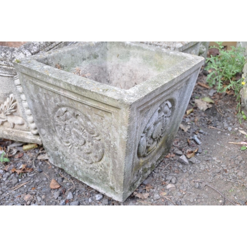 1016 - A PAIR OF SMALL COMPOSITE SQUARE GARDEN PLANTERS with foliate detail to each facet width and  depth ... 