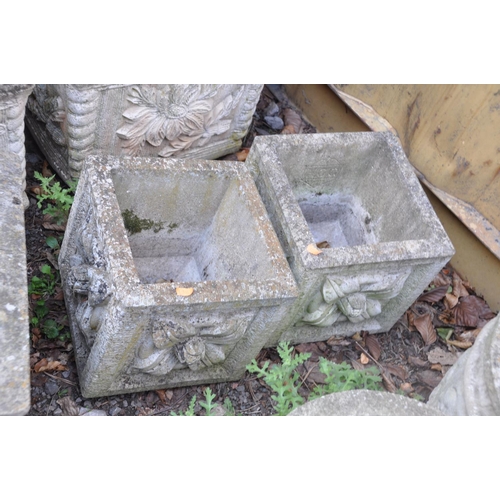 1016 - A PAIR OF SMALL COMPOSITE SQUARE GARDEN PLANTERS with foliate detail to each facet width and  depth ... 