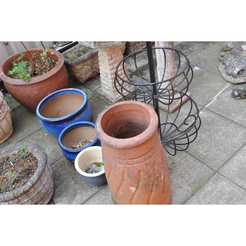 1026 - A VINTAGE TERRACOTTA CHIMNEY POT height 63cm, a large terracotta colour glazed planter diameter 52cm... 