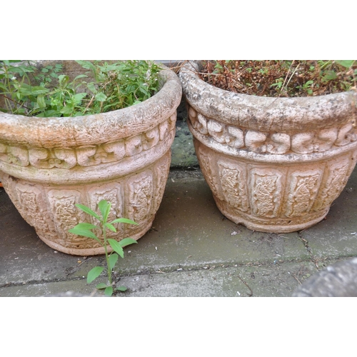 1027 - A PAIR OF COMPOSITE GARDEN PLANTERS with foliate panels to side diameter 40cm height 34cm