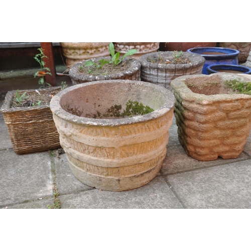 1028 - A PAIR OF COMPOSITE GARDEN PLANTERS with barrel effect detailing diameter 38cm height 39cm, and thre... 