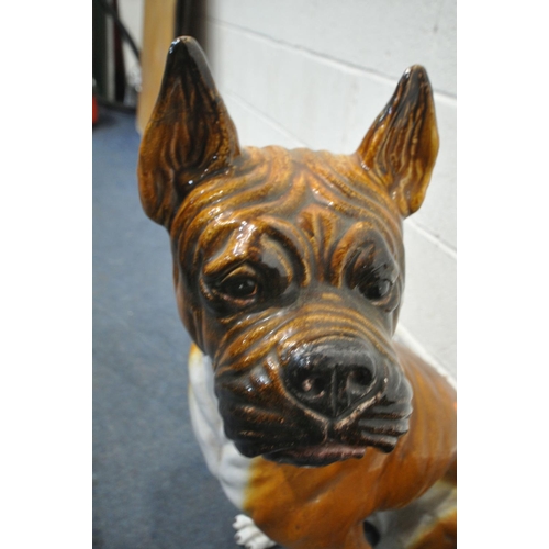 1201 - TWO CERAMIC SEATED DOG STATUES, boxer? the tallest dog height 74cm, smallest dog height 64cm (condit... 