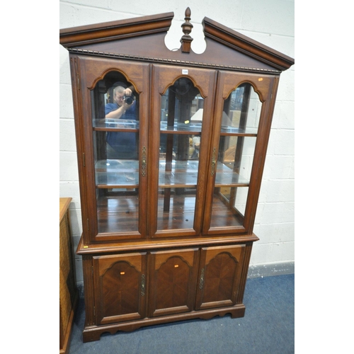 1209 - A MODERN MAHOGANY BOOKCASE, the top with two glazed doors, enclosing two glass shelves, base with tw... 