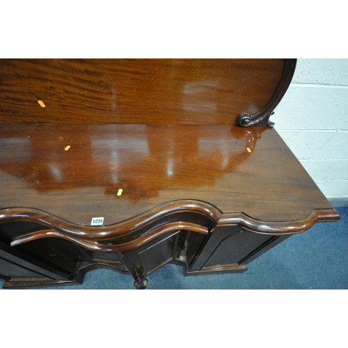 1235 - A VICTORIAN SERPENTINE SIDEBOARD, with a raised back, with two cupboard door, enclosing drawers and ... 