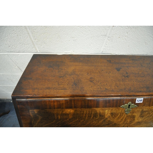 1248 - A GEORGIAN OAK AND MAHOGANY CROSS BANDED FALL FRONT BUREAU, with fitted interior, above three gradua... 