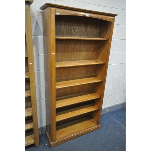 1300 - A SLIM LIGHT OAK OPEN BOOKCASE, with adjustable shelves, width 56cm x depth 24cm x height 186cm, and... 