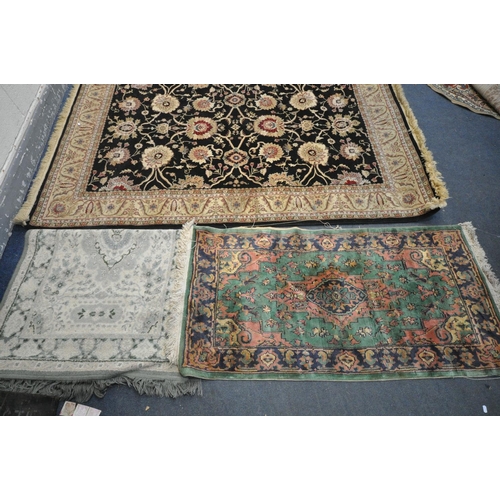 1309 - A SELECTION OF RUGS, to include a cream floral rug with a central black ground, 230cm x 160cm, a  sm... 