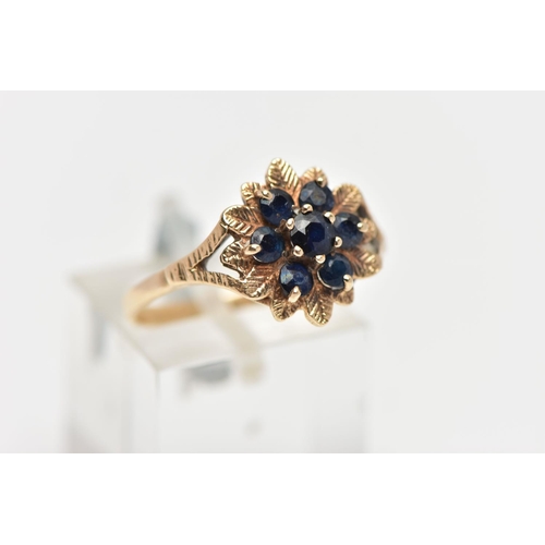 19 - A 9CT GOLD SAPPHIRE CLUSTER RING, flower shape cluster set with seven circular cut deep blue sapphir... 