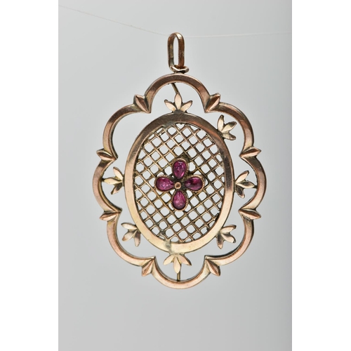 30 - A YELLOW METAL PENDANT, of openwork floral design, with pear cut garnet quatrefoil central panel, to... 