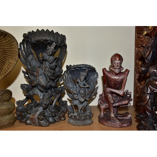 301 - EIGHT ORIENTAL AND ASIAN CARVED WOODEN SCULPTURES, to include an intricate high relief carved panel,... 