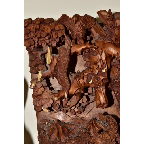 301 - EIGHT ORIENTAL AND ASIAN CARVED WOODEN SCULPTURES, to include an intricate high relief carved panel,... 