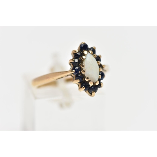 31 - A 9CT GOLD OPAL AND SAPPHIRE CLUSTER RING, the marquise opal cabochon, with circular cut sapphire su... 