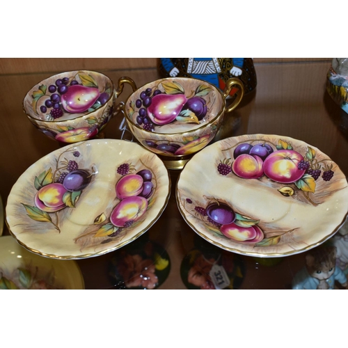 316 - A PAIR OF AYNSLEY ORCHARD GOLD TEA CUPS AND SAUCERS, with gilt handles and rims, printed with fruit ... 