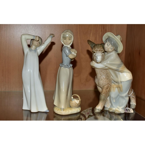 333 - THREE LLADRO AND NAO FIGURES, comprising a Lladro 'Platero and Marcelino' figure depicting a boy wit... 