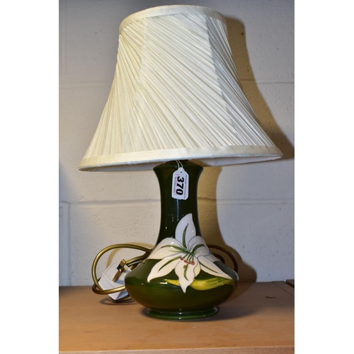 370 - A MOORCROFT POTTERY 'BERMUDA LILY' TABLE LAMP, the tube lined pattern on a green ground, height incl... 