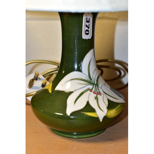 370 - A MOORCROFT POTTERY 'BERMUDA LILY' TABLE LAMP, the tube lined pattern on a green ground, height incl... 