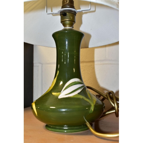 370 - A MOORCROFT POTTERY 'BERMUDA LILY' TABLE LAMP, the tube lined pattern on a green ground, height incl... 