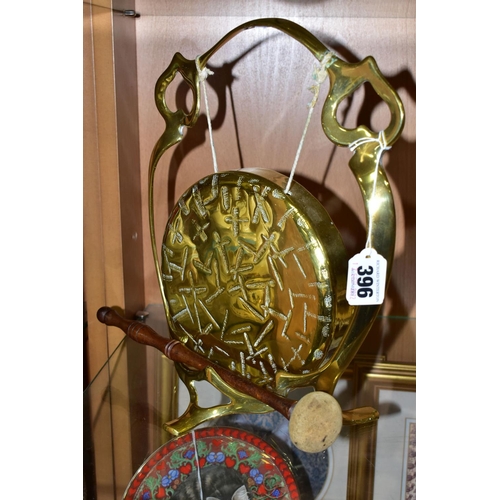 396 - A BRASS TABLE GONG, suspended from a brass frame, with wooden handled beater, frame is stamped with ... 