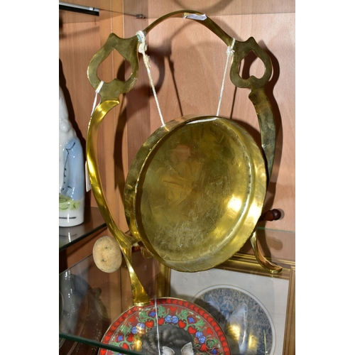 396 - A BRASS TABLE GONG, suspended from a brass frame, with wooden handled beater, frame is stamped with ... 